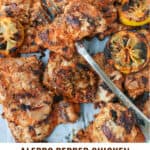 Pinterest pin: grilled chicken thighs and grilled lemons with a forked stabbed through one thigh